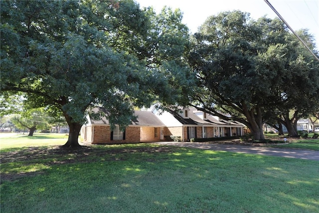 view of side of home with a lawn