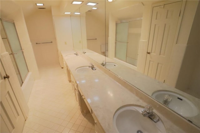 bathroom with tile patterned floors, vanity, and an enclosed shower