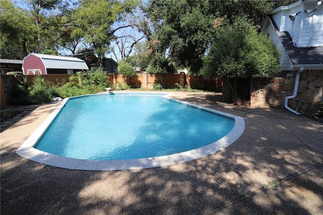 view of pool featuring a diving board