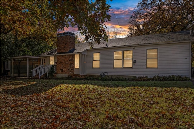 exterior space with a chimney and a yard