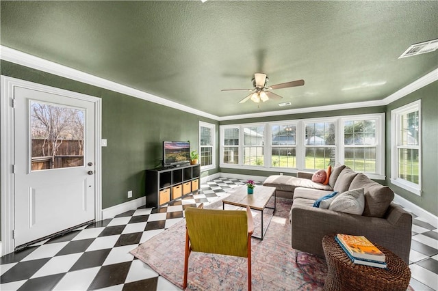 living room with ornamental molding, a textured ceiling, and a healthy amount of sunlight