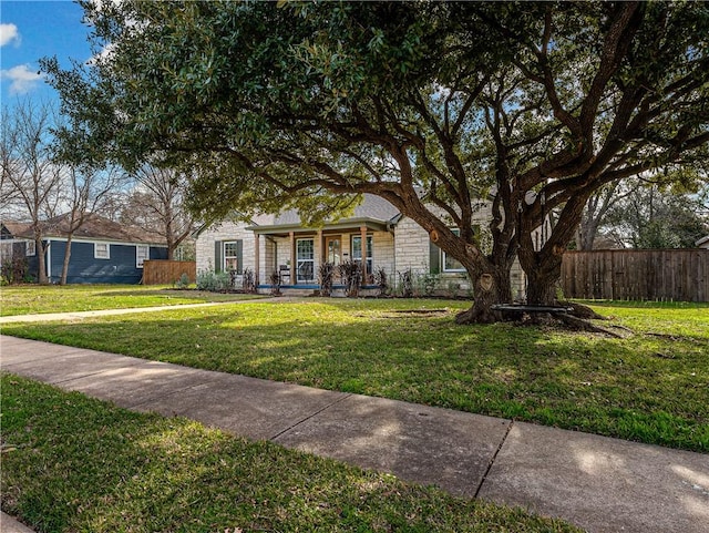 ranch-style house featuring a front lawn and a porch