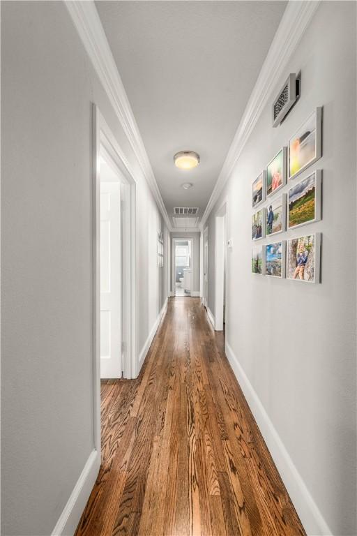 hall featuring hardwood / wood-style flooring and ornamental molding