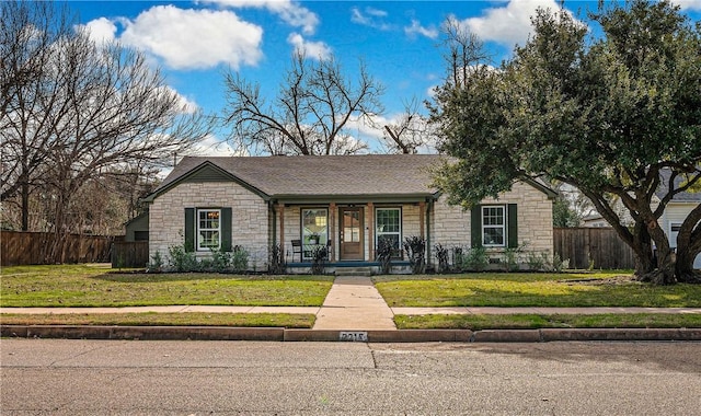 single story home featuring a porch and a front yard