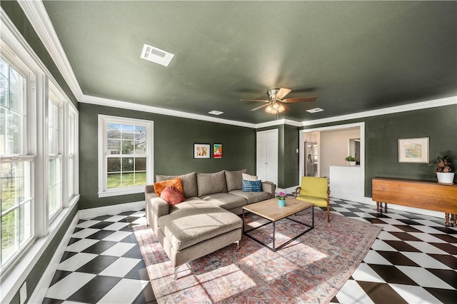 living room featuring a wealth of natural light, ceiling fan, and ornamental molding