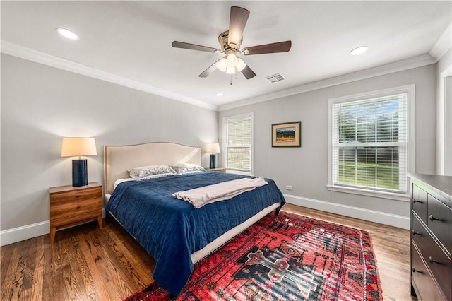 bedroom with ceiling fan, dark hardwood / wood-style floors, and multiple windows