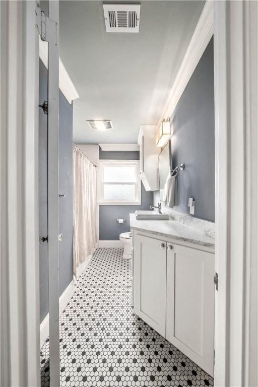 bathroom featuring tile patterned floors, vanity, and toilet