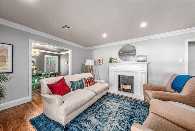 living room with dark wood-type flooring and ornamental molding