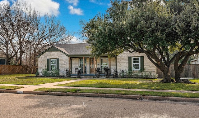 ranch-style home with a porch and a front lawn