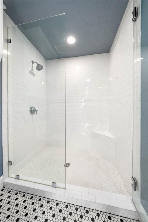 bathroom with tile patterned flooring and a shower with door