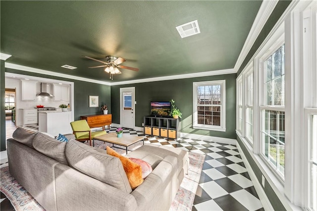 living room featuring ceiling fan and ornamental molding