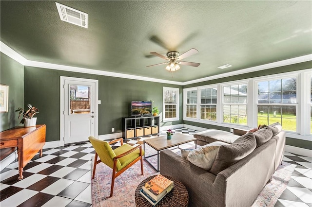 living room featuring ceiling fan, crown molding, and a textured ceiling