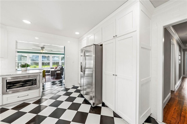 kitchen featuring white cabinetry, ceiling fan, dark hardwood / wood-style floors, stainless steel refrigerator with ice dispenser, and crown molding