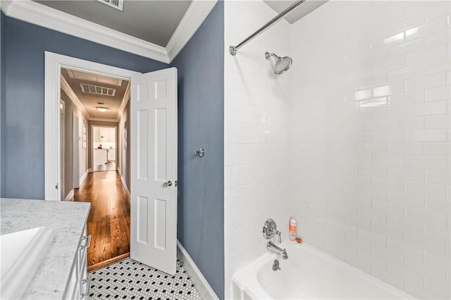 bathroom with crown molding, vanity, wood-type flooring, and tiled shower / bath