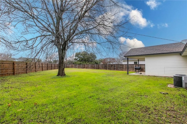 view of yard featuring central AC and a patio