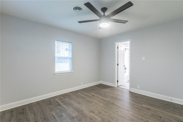 empty room featuring dark hardwood / wood-style flooring and ceiling fan