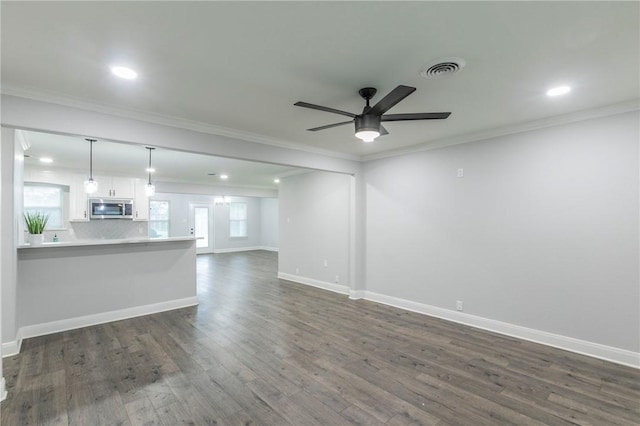 unfurnished living room featuring crown molding, dark wood-type flooring, and ceiling fan