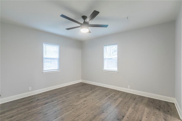 unfurnished room with dark wood-type flooring, a wealth of natural light, and ceiling fan