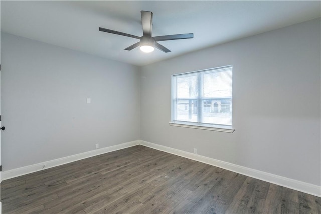 unfurnished room with ceiling fan and dark hardwood / wood-style flooring