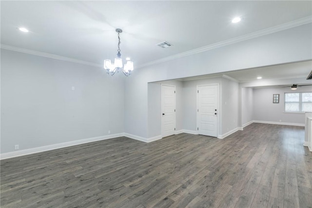 spare room with ornamental molding, dark hardwood / wood-style floors, and ceiling fan with notable chandelier