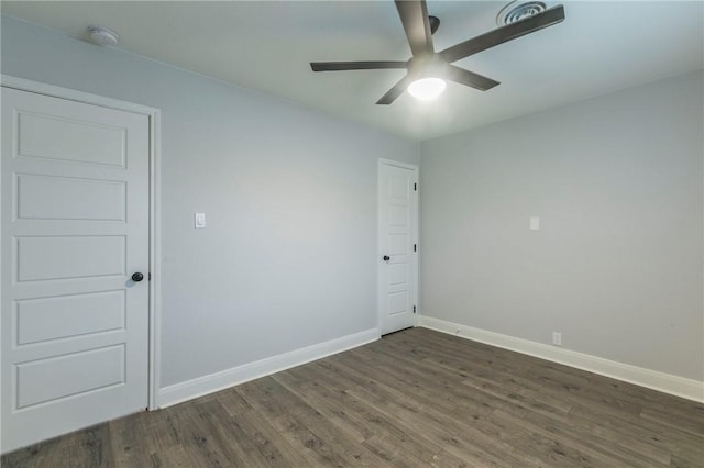 spare room with dark hardwood / wood-style floors and ceiling fan