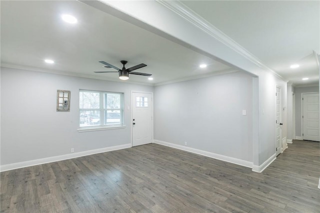 interior space with ornamental molding, ceiling fan, and dark hardwood / wood-style flooring