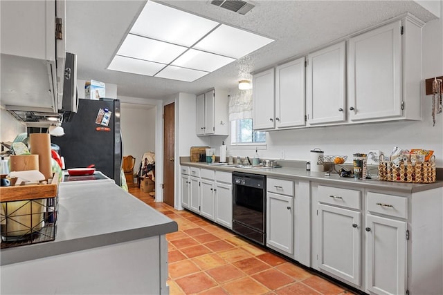 kitchen featuring black appliances, white cabinets, and a textured ceiling