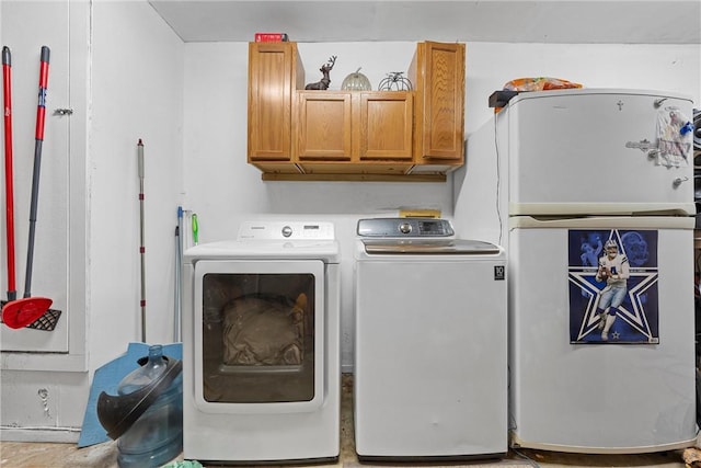 laundry area with cabinets and independent washer and dryer