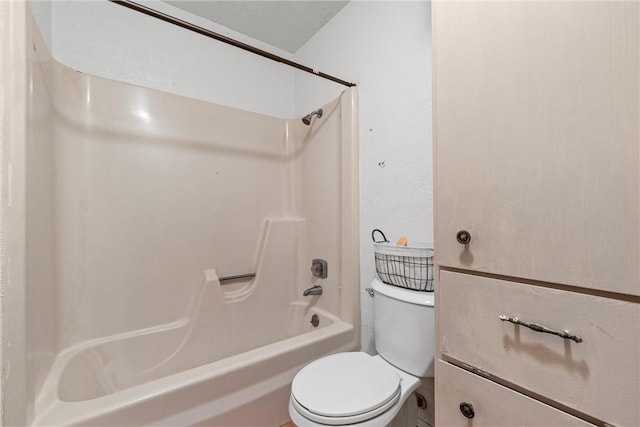 bathroom with tub / shower combination and toilet