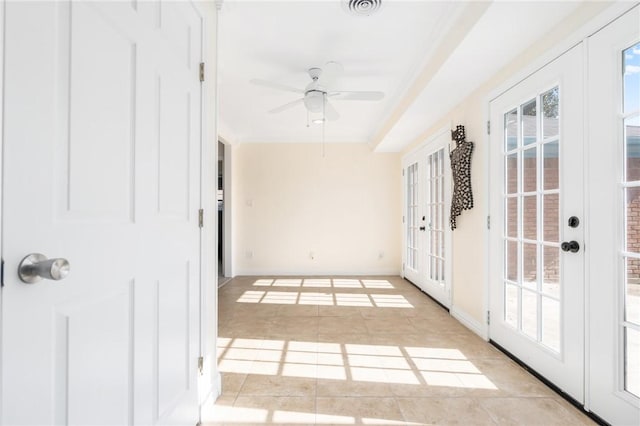 entryway with ceiling fan, light tile patterned floors, crown molding, and french doors