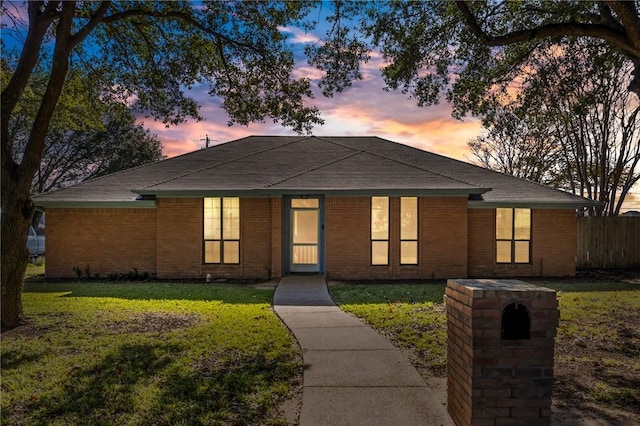 ranch-style home with a yard