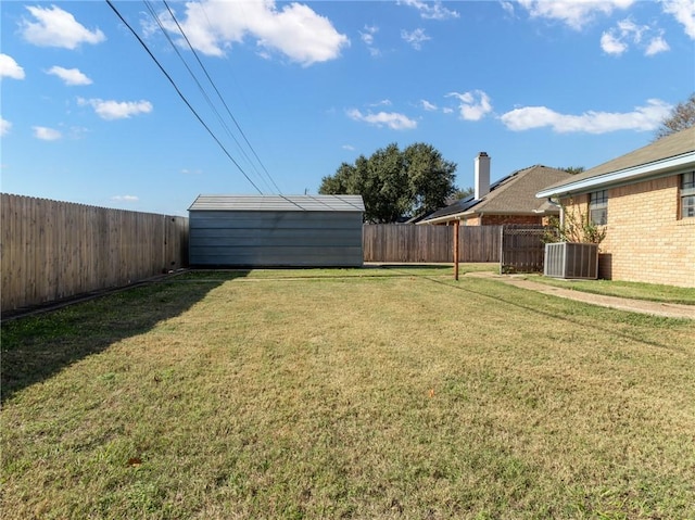 view of yard featuring central air condition unit and a storage shed