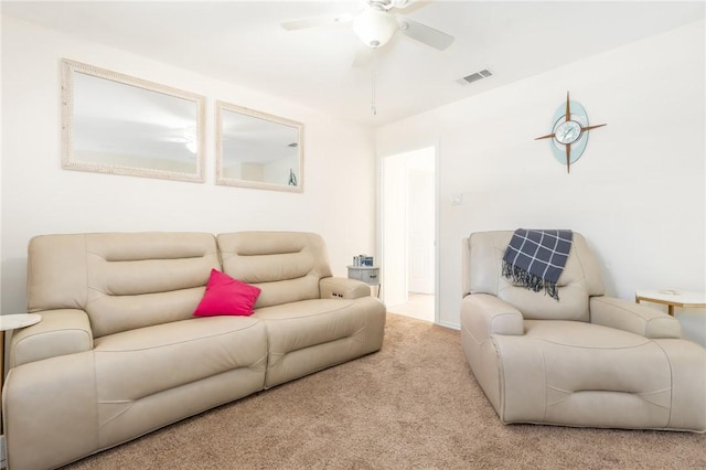 carpeted living room with ceiling fan