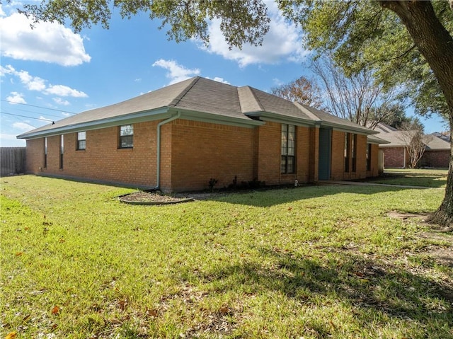 view of side of home with a lawn