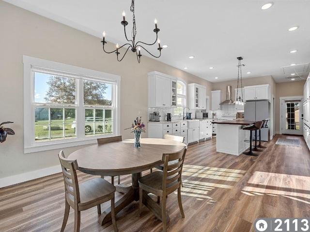 dining space with hardwood / wood-style flooring and sink