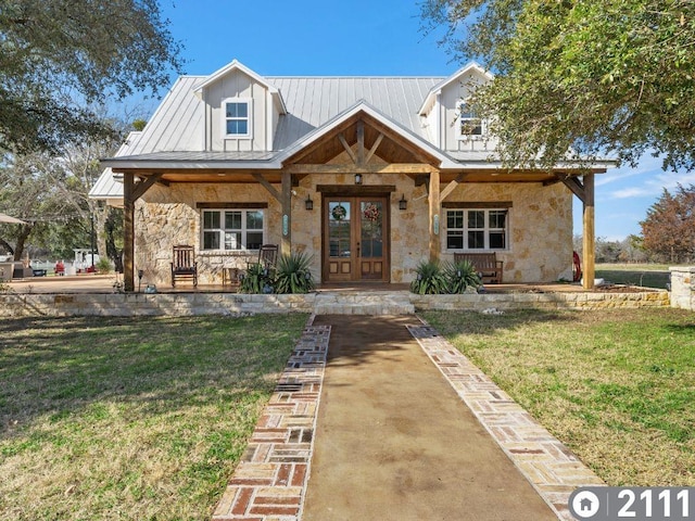 view of front facade featuring a front yard, french doors, and a porch