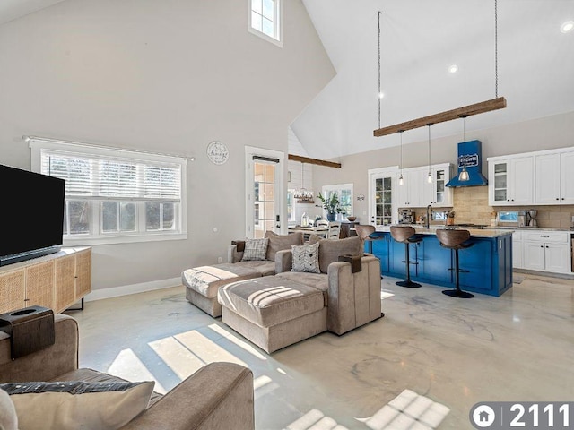 living room featuring french doors, a towering ceiling, and plenty of natural light