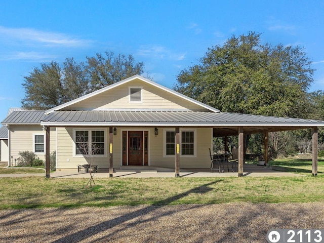 view of front of house with a patio and a front yard