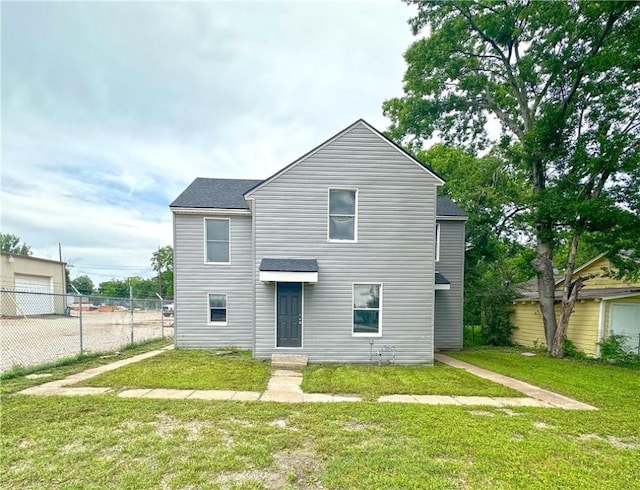 rear view of property with a lawn