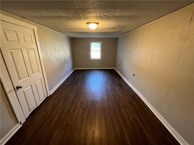 spare room featuring dark wood-type flooring