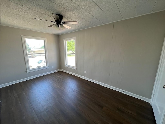 unfurnished room featuring ceiling fan and dark hardwood / wood-style floors