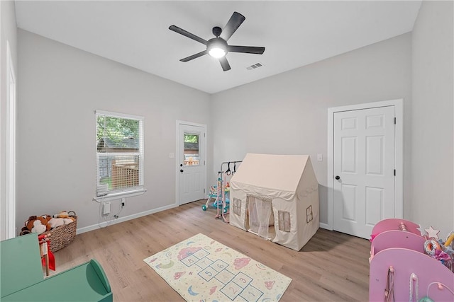 rec room with ceiling fan and light hardwood / wood-style floors