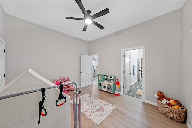 recreation room featuring ceiling fan and light hardwood / wood-style floors