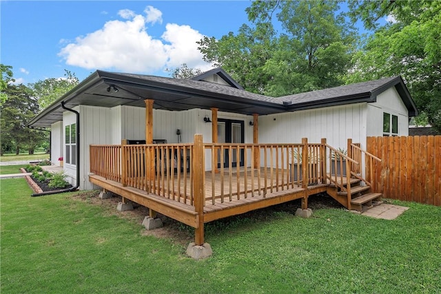 back of house with a yard and a wooden deck