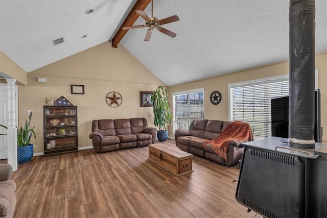 living room with ceiling fan, wood-type flooring, and a textured ceiling