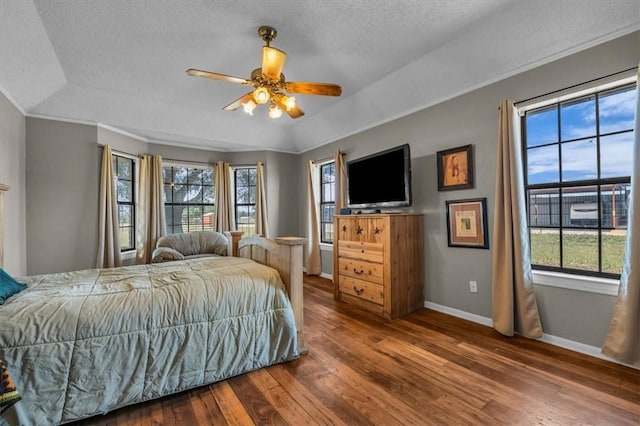 bedroom with multiple windows, a textured ceiling, hardwood / wood-style flooring, and ceiling fan