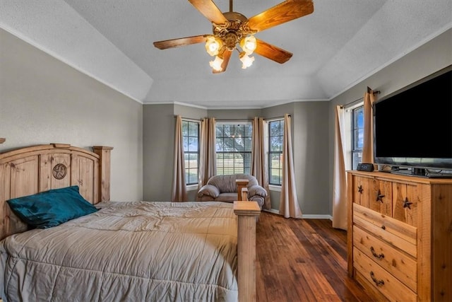 bedroom with crown molding, vaulted ceiling, dark hardwood / wood-style floors, ceiling fan, and a textured ceiling