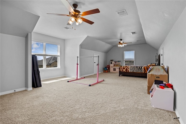 carpeted bedroom featuring baseboards, visible vents, and vaulted ceiling