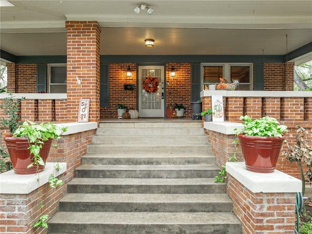 view of exterior entry featuring a porch