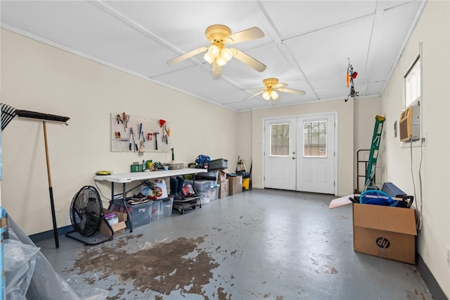 garage with a wall mounted AC, ceiling fan, and french doors